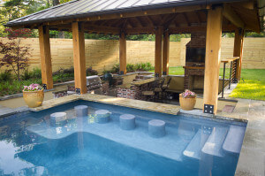A custom designed pool featuring bar stools built into the pool.