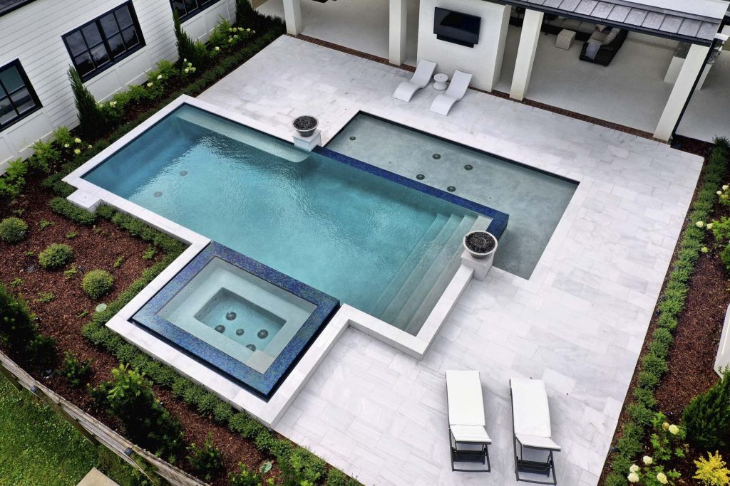 Custom pool with spa and tanning ledge by pool builders in Gonzalez, LA